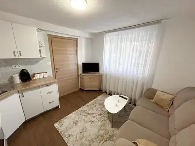 a small living room with a couch and a table at New apartment - Moon in Banja Luka