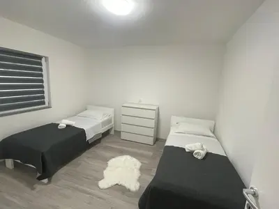 a small bedroom with two beds and a dresser at Apartmani Franciska in Jajce