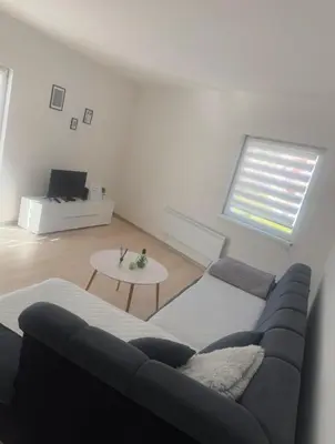 a living room with a couch and a table at Apartmani Franciska in Jajce