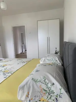 a bedroom with a bed with a blanket on it at Apartman TESA in Sanski most