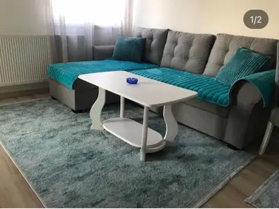 a living room with a couch and a table at Stan na dan Tamaris in Modriča