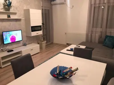 a living room with a table with a bowl of toys on it at Stan na dan Tamaris in Modriča
