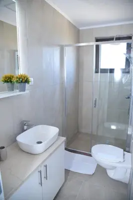 a bathroom with a shower and a sink and a toilet at Vb apartmani in Prijedor