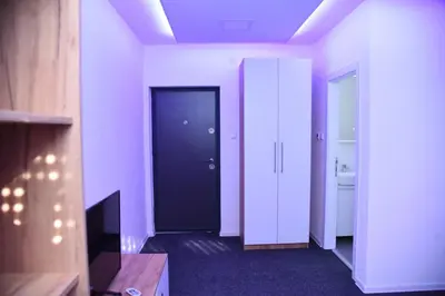 a hallway with a black door in a room at Vb apartmani in Prijedor