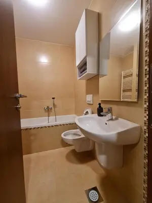 a bathroom with a sink and a toilet and a tub at AGERA Apartments in Banja Luka