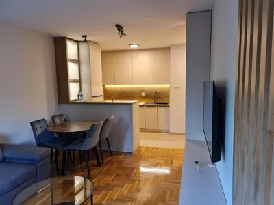 a living room and kitchen with a couch and a table at AGERA Apartments in Banja Luka