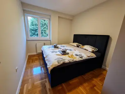 a bedroom with a bed in a room with a window at AGERA Apartments in Banja Luka