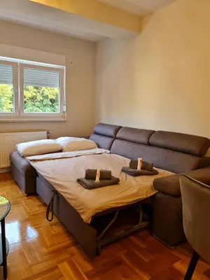 a large bed in a room with a couch at AGERA Apartments in Banja Luka