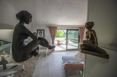 a living room with a statue of two girls on the wall at R&J's Home in Bihać