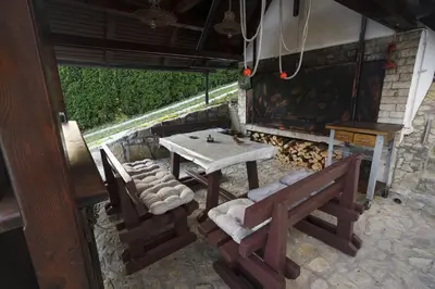 a table and two chairs and a table and bench at R&J's Home in Bihać