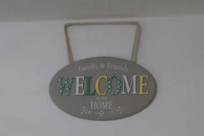 a welcome sign hanging on a ceiling at Ema Apartman in Livno