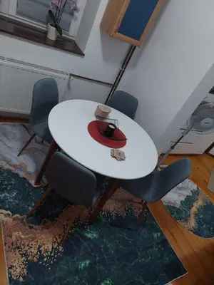a white table with chairs and a hat on it at Ema Apartman in Livno