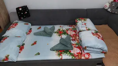 a couch with christmas pillows on top of it at Ema Apartman in Livno