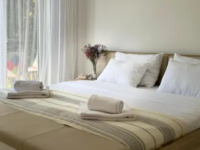 a bed with towels on it with a window at Apartment DUNJA Laktasi in Laktaši