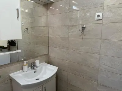 a bathroom with a sink and a shower at Apartment DUNJA Laktasi in Laktaši