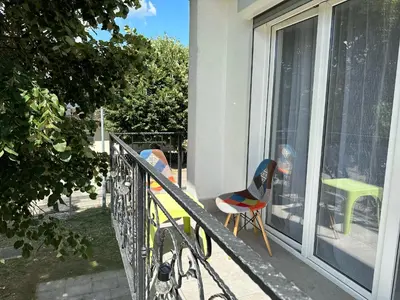 a balcony with two chairs and a bike on it at Apartment DUNJA Laktasi in Laktaši