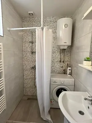 a bathroom with a washing machine and a sink at Apartment DUNJA Laktasi in Laktaši