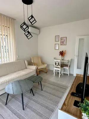 a living room with a couch and a table at Apartment DUNJA Laktasi in Laktaši