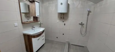 a bathroom with a sink and a shower at Apartman Citadel in Gradačac