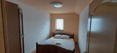a small bedroom with a bed and a window at Apartman Citadel in Gradačac