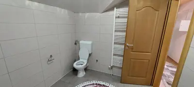 a small bathroom with a toilet and a door at Apartman Citadel in Gradačac
