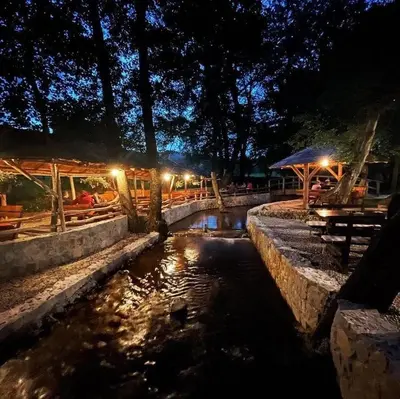a small pond in a park at night at Etno zona Oaza mira in Donji Vakuf