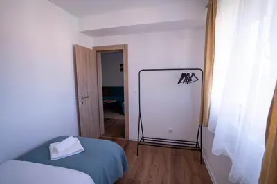 a room with a bed and a white wall at Apartman Niko in Livno