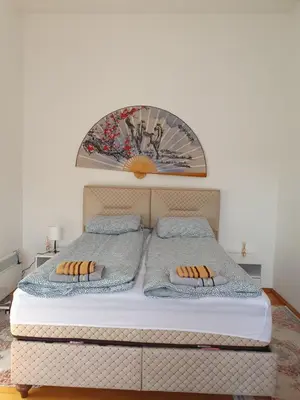 a white bed with two pillows on top of it at OLD HOUSE in Jajce