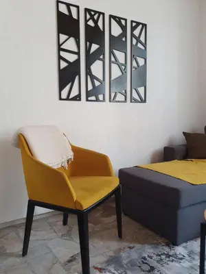 a bedroom with a yellow chair and a bed at OLD HOUSE in Jajce