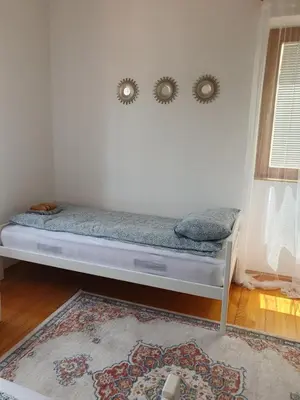 a bed in a room with two mirrors on the wall at OLD HOUSE in Jajce