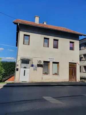 a building with a door on the side of a street at OLD HOUSE in Jajce