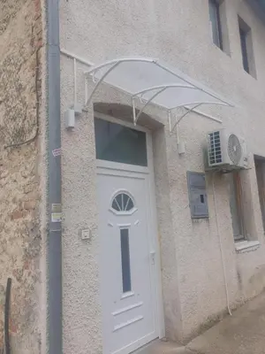 a white door on a building with a fan at OLD HOUSE in Jajce