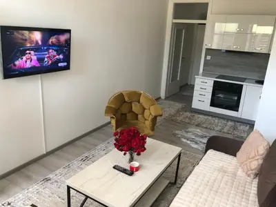 a living room with a vase of flowers on a table at Apartman 555 in Travnik