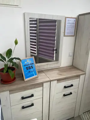 a wooden dresser with a window and a sign on it at Apartman 555 in Travnik