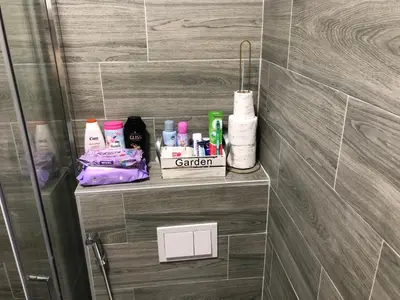 a bathroom with a shelf with toiletries on it at Apartman 555 in Travnik