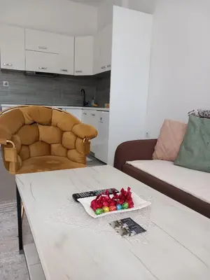 a living room with a table and a couch at Apartman 555 in Travnik