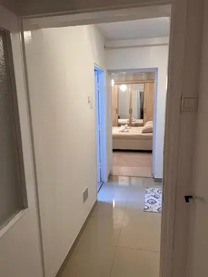 a hallway leading to a bedroom with a bathroom at Apartman Krasota in Banja Luka