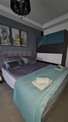 a bedroom with a large bed with a towel on it at Apartman Silver in Bugojno