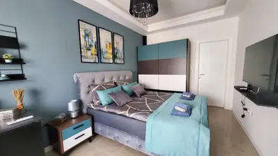a small bedroom with a bed and a tv at Apartman Silver in Bugojno