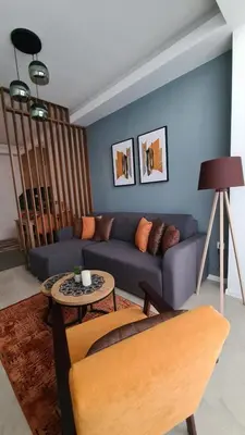 a living room with a blue couch and a table at Apartman Orange in Bugojno
