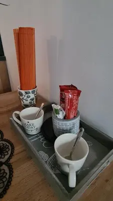 a tray with three bowls on a table at Apartman Orange in Bugojno