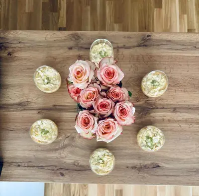 a bouquet of pink roses on a wooden table at Summer house LejHana in Bihać