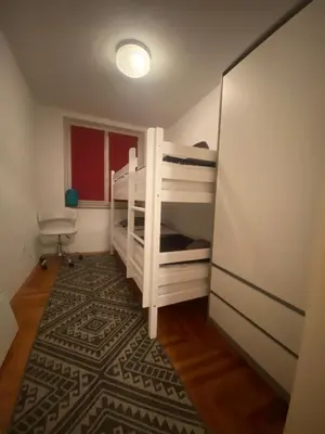 a bedroom with two bunk beds and a rug at Capital Apartments Visoko in Visoko