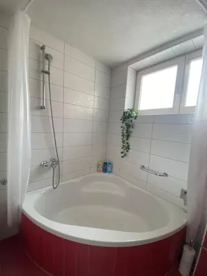 a large tub in a bathroom with a window at Capital Apartments Visoko in Visoko