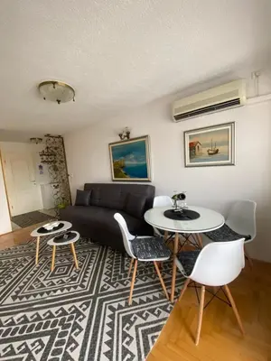 a living room with a couch and a table and chairs at Capital Apartments Visoko in Visoko