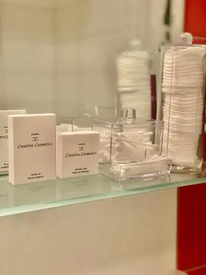 a glass shelf with three boxes of towels at Capital Apartments Visoko in Visoko