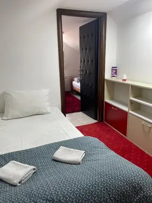 a bedroom with a bed with two towels on it at Apartmani Kotor Varoš in Donja Varoš