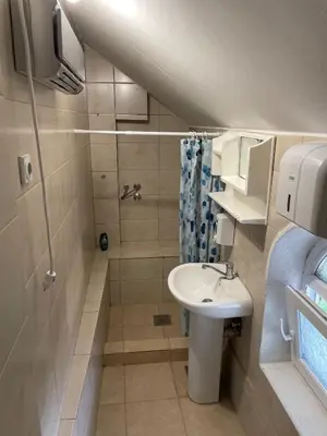 a small bathroom with a sink and a shower at Apartmani Kotor Varoš in Donja Varoš