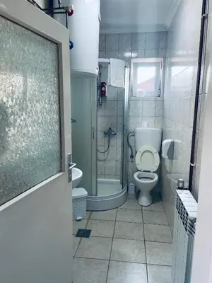 a bathroom with a toilet and a shower at Apartmani Kotor Varoš in Donja Varoš