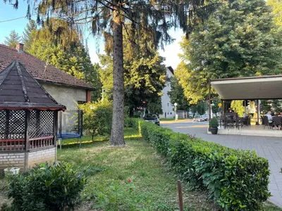 a park with a gazebo and a tree at Apartmani Kotor Varoš in Donja Varoš